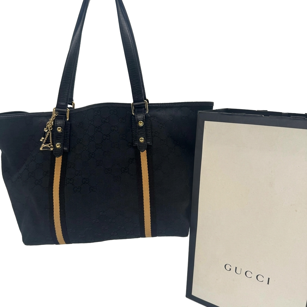 Sac à main Abbey tote Gucci en toile GG canvas noire avec son sac marchand Gucci