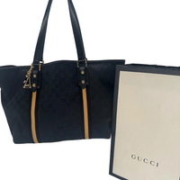 Sac à main Abbey tote Gucci en toile GG canvas noire avec son sac marchand Gucci